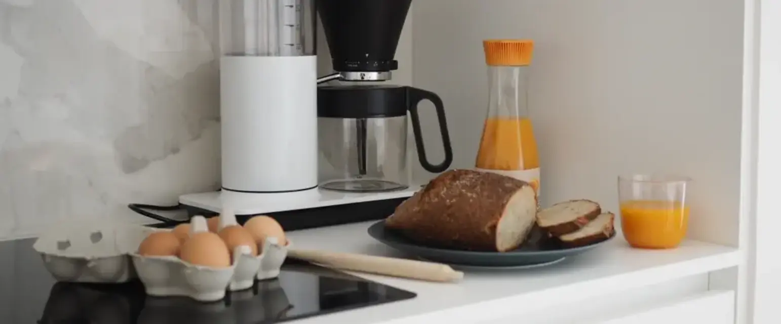 a kitchen counter with food and juice