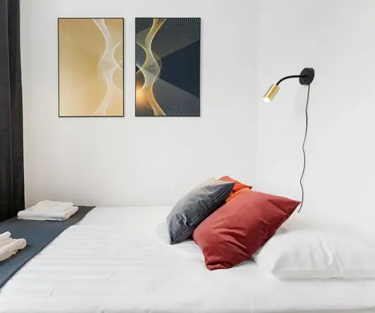 a bed with pillows and towels on it