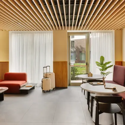 a room with chairs and tables and luggage