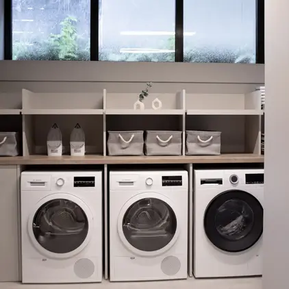 a laundry room with white appliances