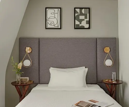 a bed with a magazine and two nightstands