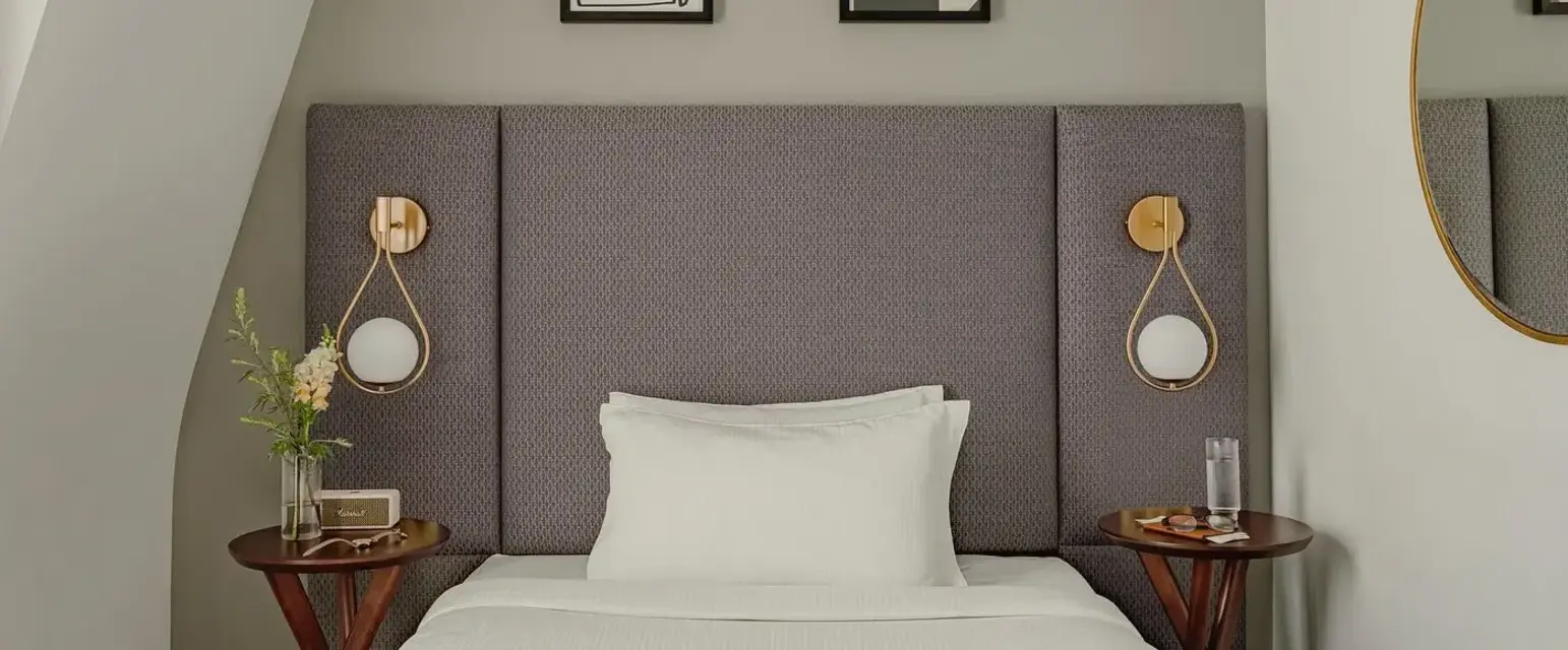 a bed with a magazine and two nightstands