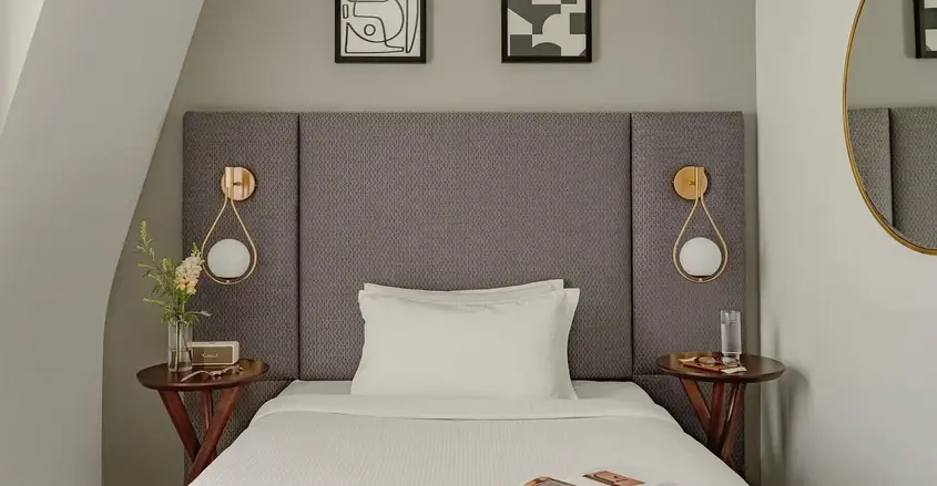 a bed with a magazine and two nightstands