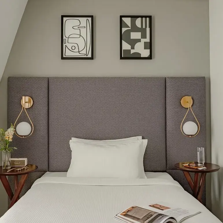 a bed with a magazine and two nightstands