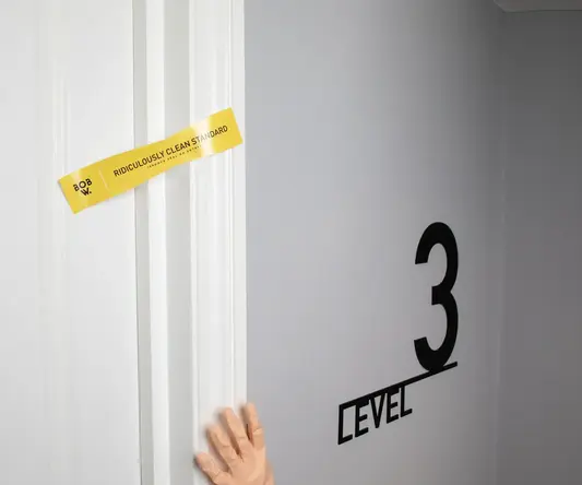 a hand in a glove reaching to a door