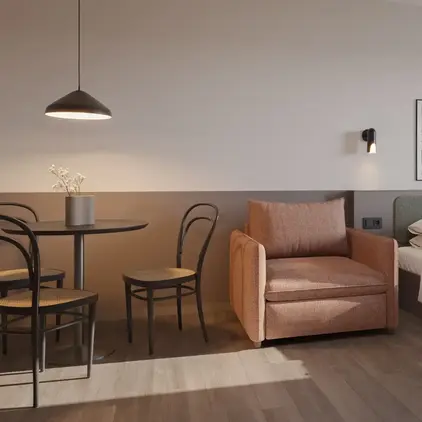 a bedroom with a bed and chair