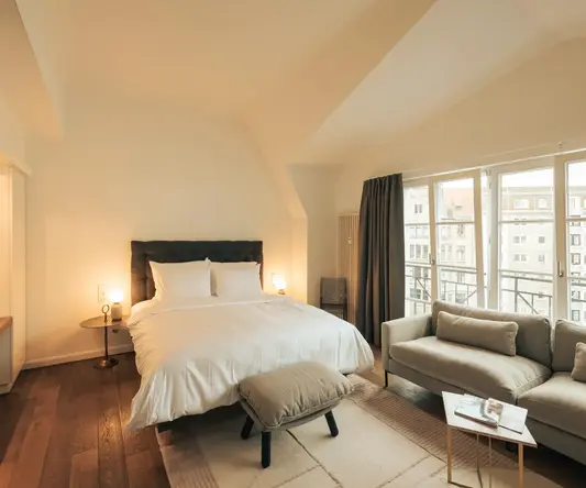 a bedroom with a bed and a couch