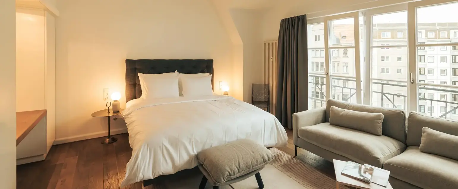 a bedroom with a bed and a couch