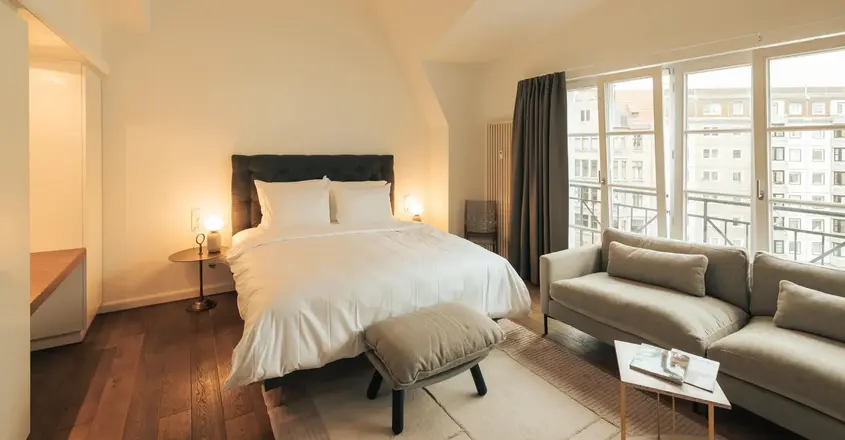 a bedroom with a bed and a couch