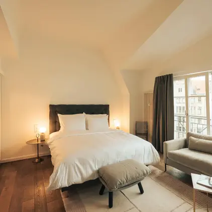 a bedroom with a bed and a couch