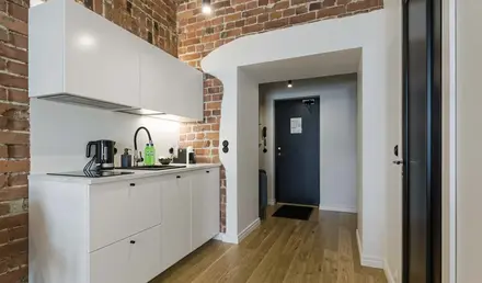 a kitchen with brick walls and a door