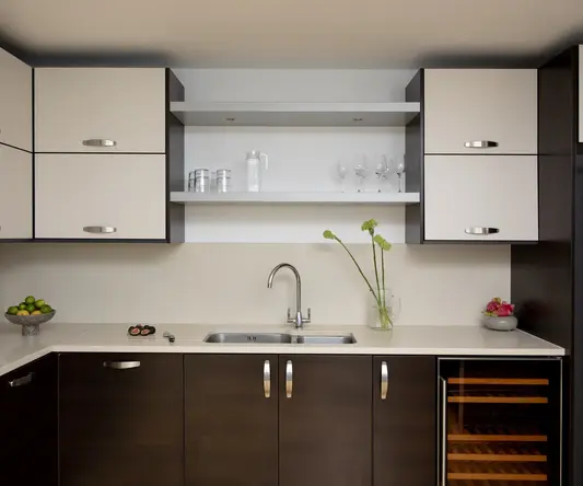 a kitchen with white cabinets and white countertops