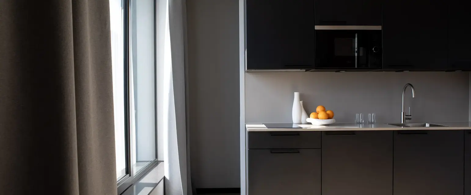 a kitchen with a bowl of oranges