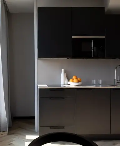 a kitchen with a bowl of oranges