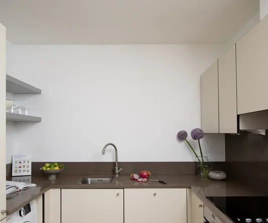 a kitchen with white cabinets and a sink
