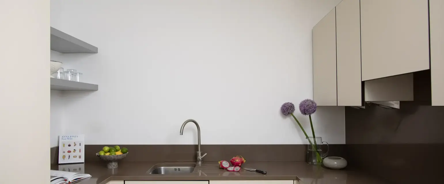 a kitchen with white cabinets and a sink