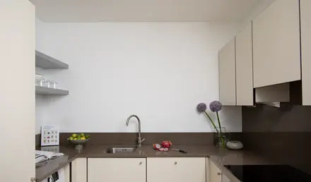 a kitchen with white cabinets and a sink