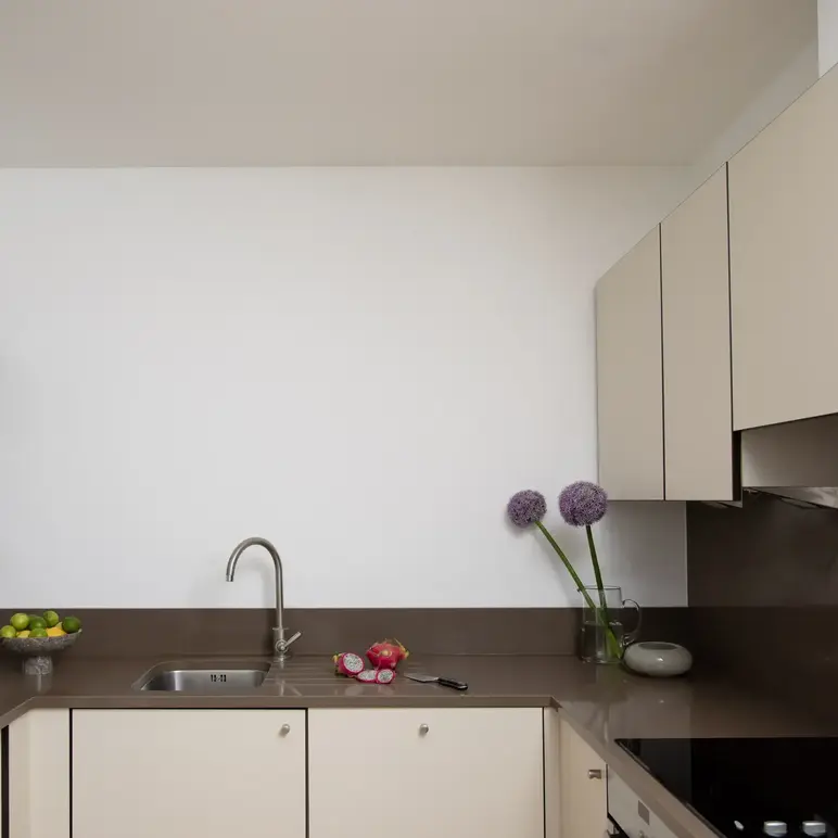 a kitchen with white cabinets and a sink