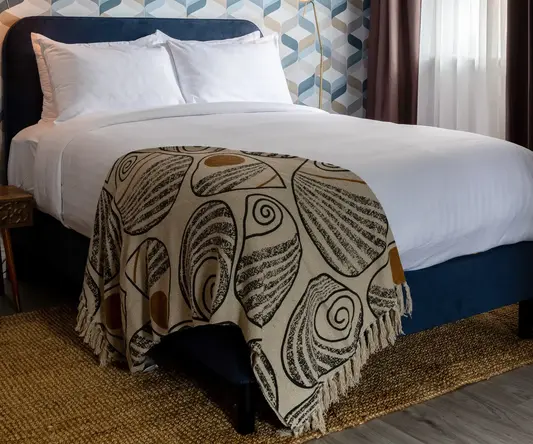 a bed with a patterned blanket in a room