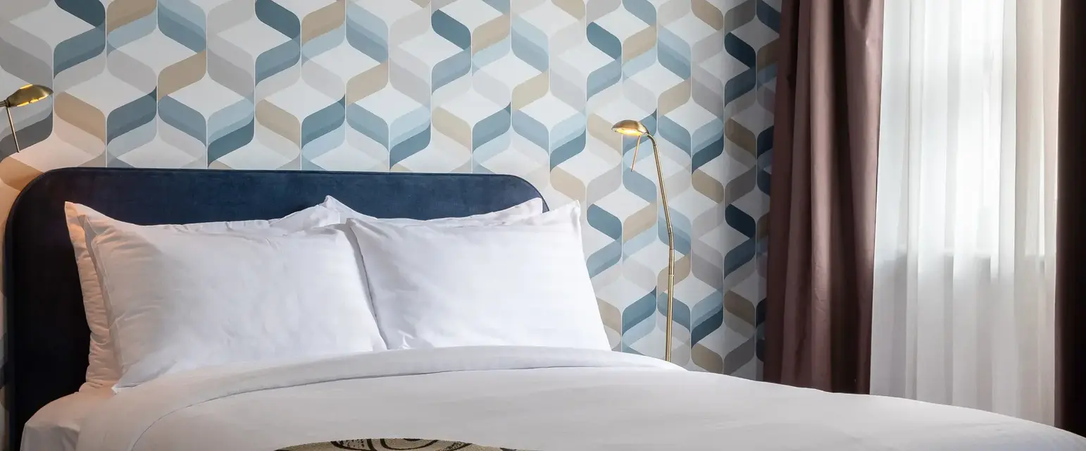 a bed with a patterned blanket in a room