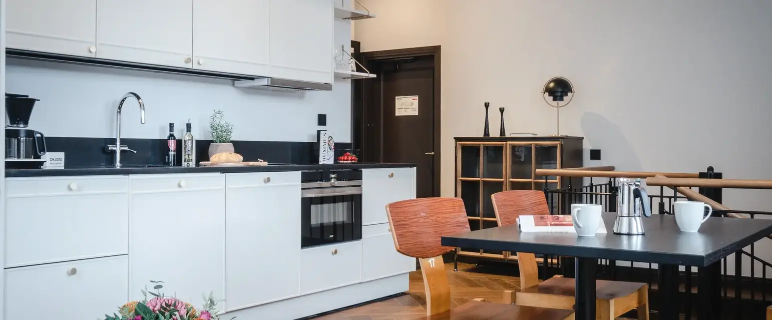 a kitchen with white cabinets and a table