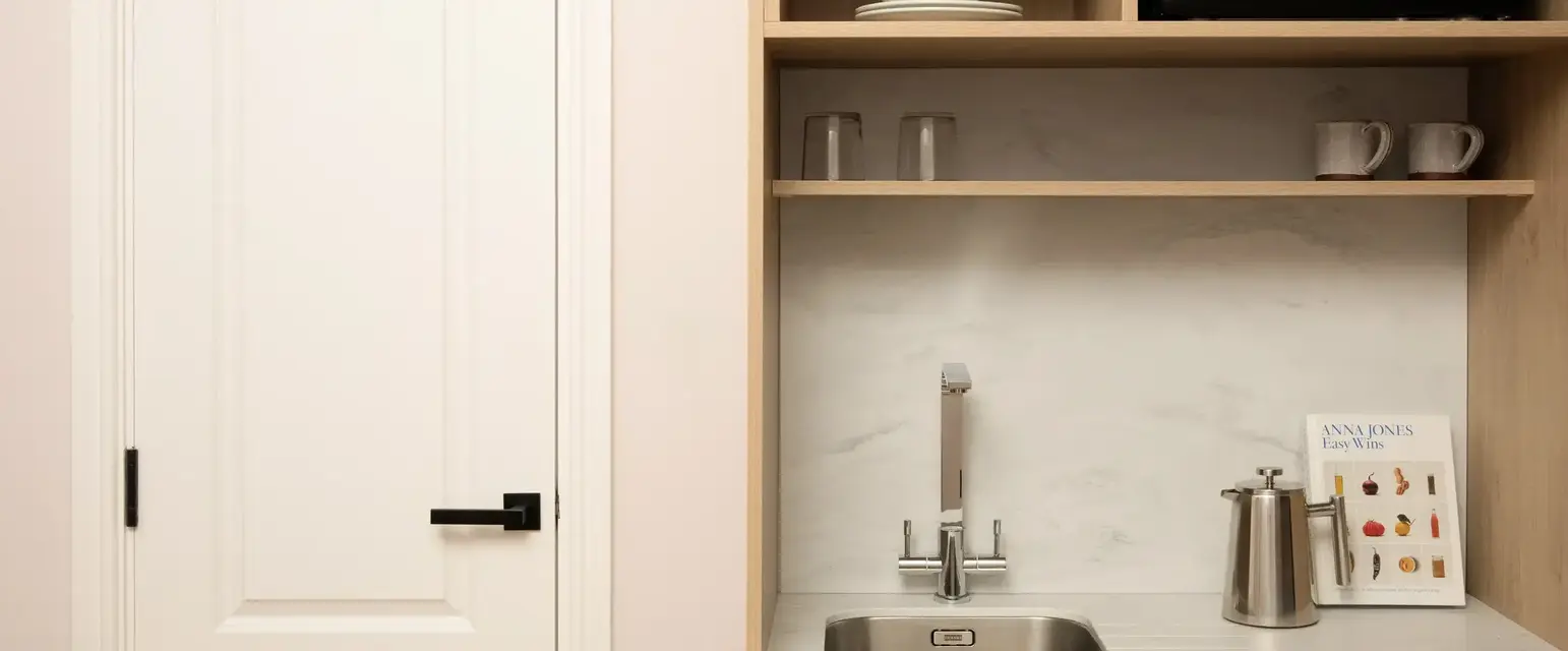 a kitchen with a microwave and a sink