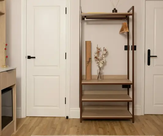 a shelf with a vase and a swinger in front of a door