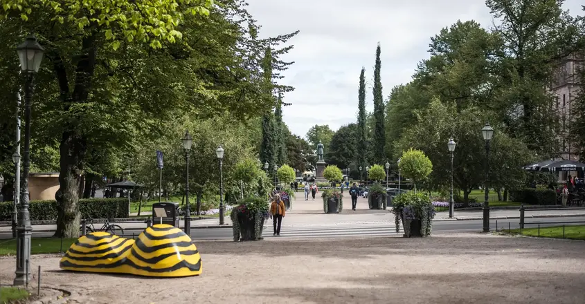 a park with a statue of a shoe