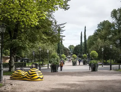 a park with a statue of a shoe