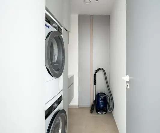 a vacuum cleaner next to a washing machine