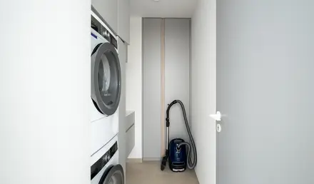 a vacuum cleaner next to a washing machine