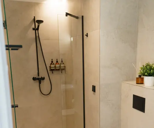 a bathroom with a glass shower door