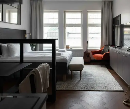 a room with a bed and a guitar