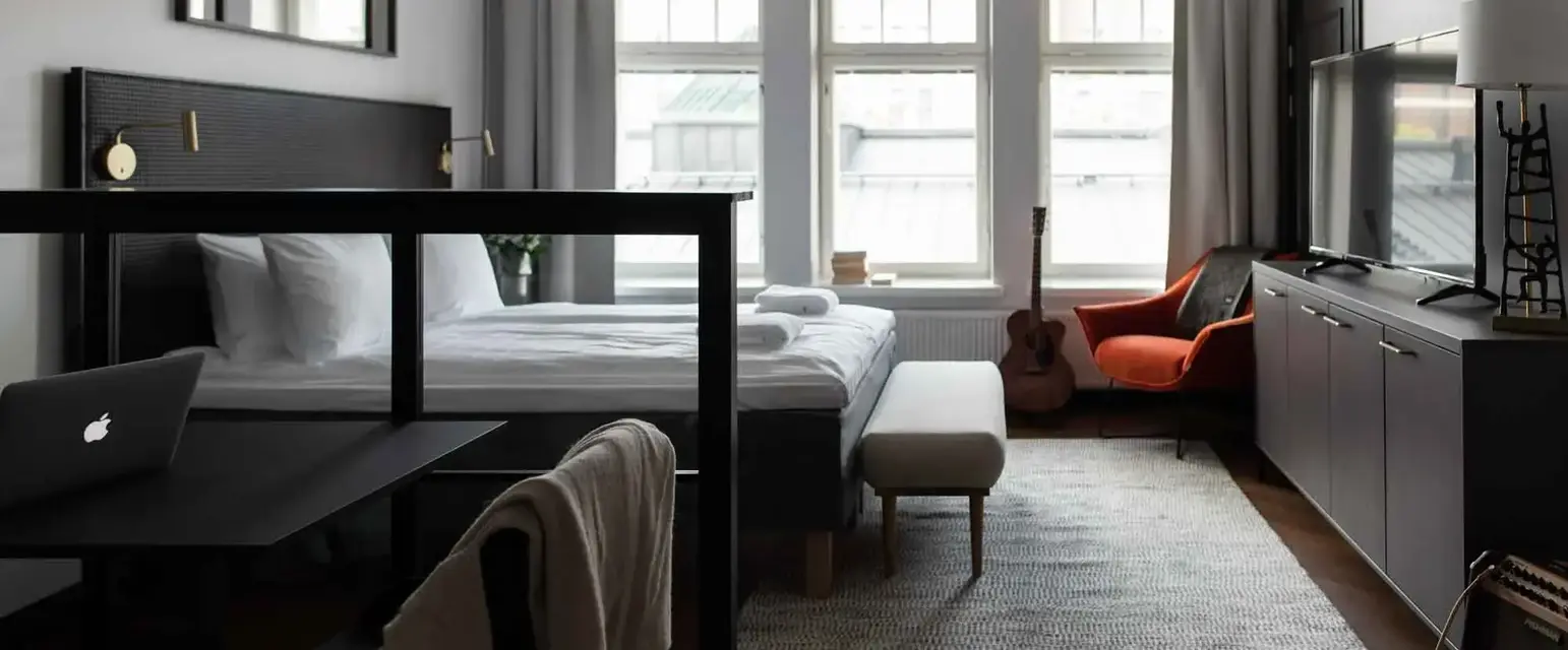 a room with a bed and a guitar