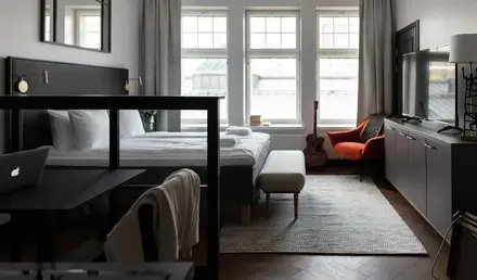 a room with a bed and a guitar