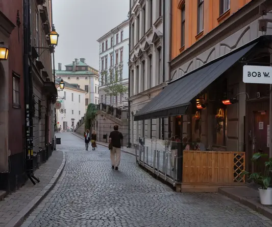 a man walking down a cobblestone street