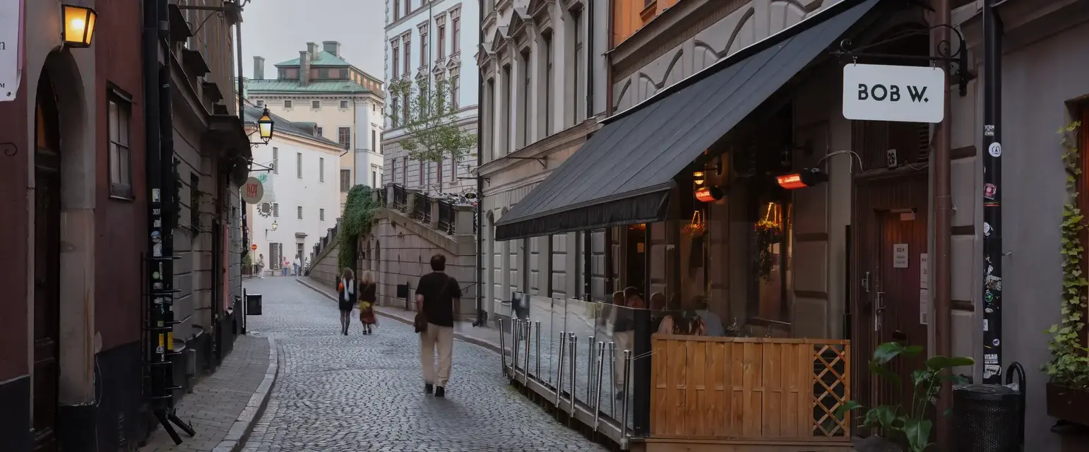 a man walking down a cobblestone street