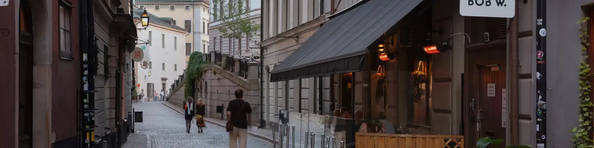 a man walking down a cobblestone street