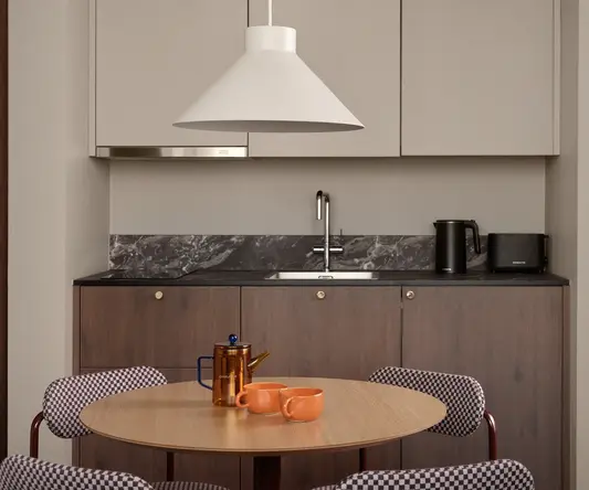 a kitchen with a table and chairs