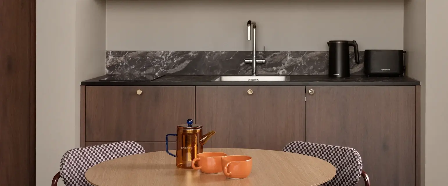 a kitchen with a table and chairs