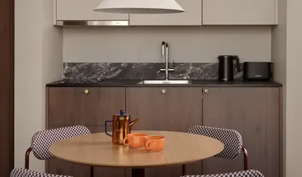 a kitchen with a table and chairs