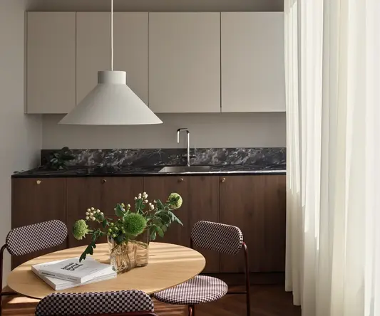 a kitchen with a table and chairs
