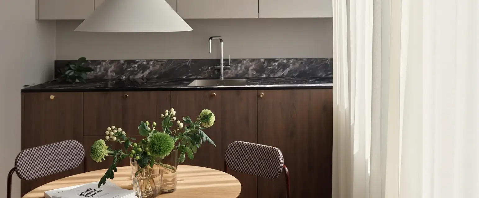 a kitchen with a table and chairs