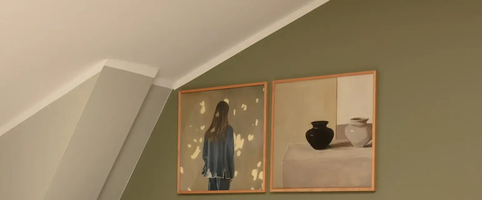 a bed with pillows and a lamp on the side