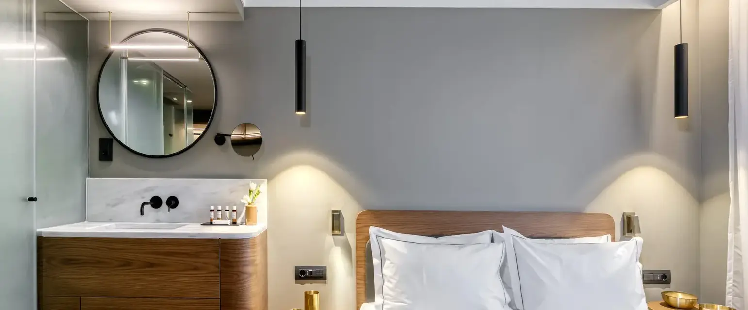 a bedroom with a round mirror and a bed