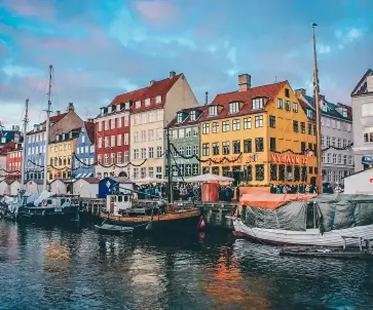 a water with boats and buildings in the background