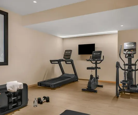a room with treadmills and exercise equipment
