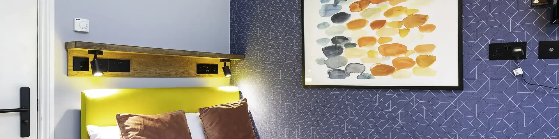 a bed with towels and a painting on the wall