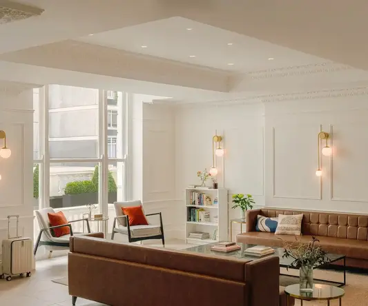 a room with a couch and chairs