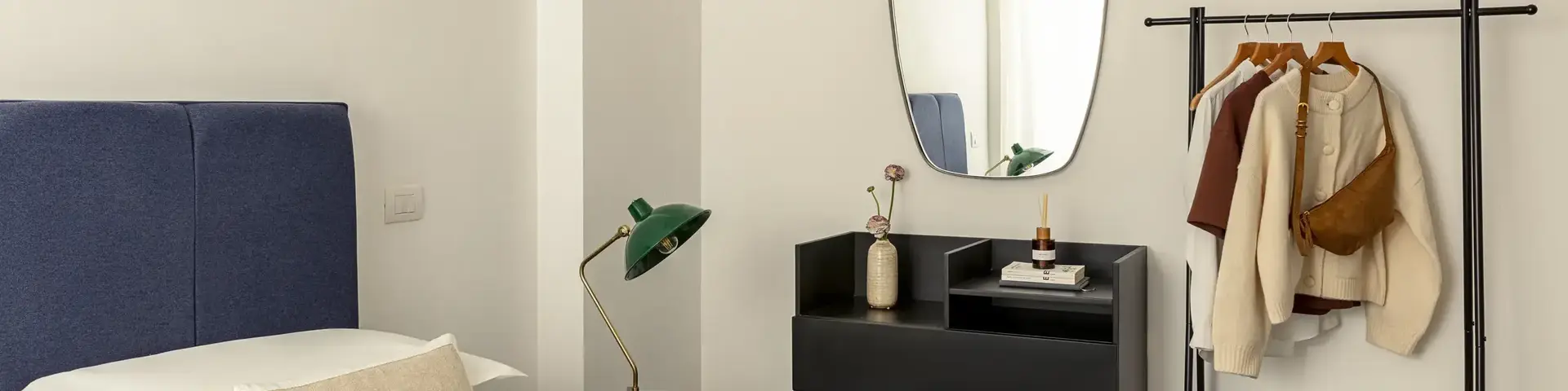 a room with a mirror and a bed